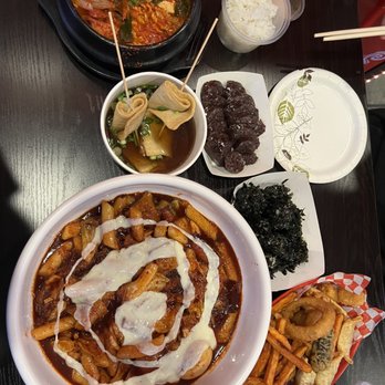 Luv Dduk - Full view of our table with budae jjigae, odeng, soondae, rice balls, tteokbokki, and tempura - Korean Near Me - Cerritos, California