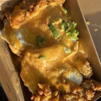 Rise Southern Biscuits & Righteous Chicken - BIG BREAKFAST BOX WITH TOTS, TWO FRIED EGGS, CHICKEN TENDERS, BOOM BOOM SAUCE, CHEDAR CHEESE AND GREEN ONION $12.57 - Chicken Shop Near Me - Winter Park, Florida