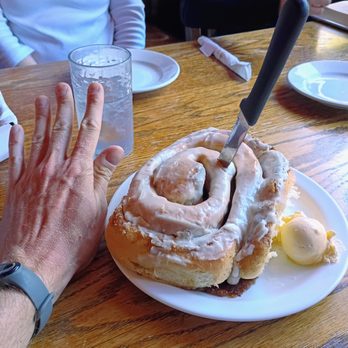 Camp 18 Restaurant - Cinnamon Roll in comparison to my hand - American Near Me - Seaside, Oregon