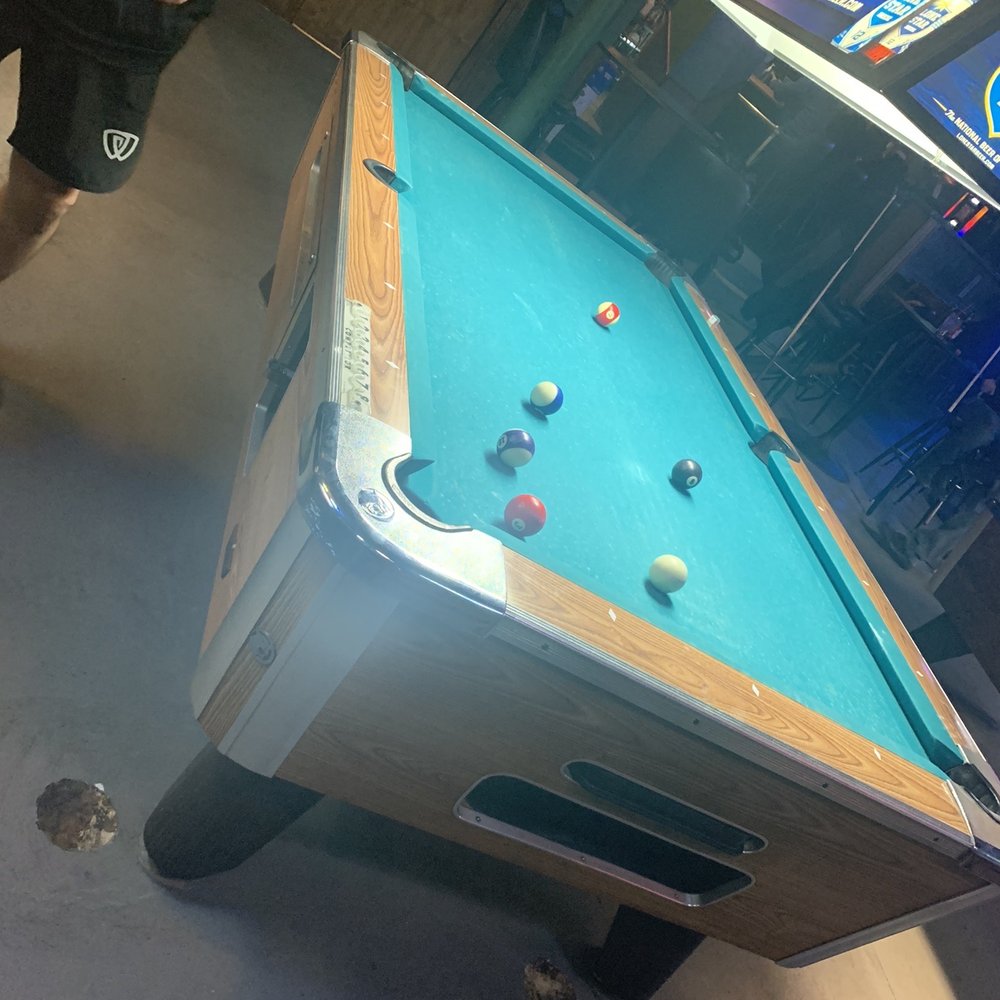 a pool table in a bar a pool table in a bar