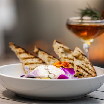 Fire Restaurant & Lounge - a bowl of food and a glass of wine - New American Near Me - Denver, Colorado