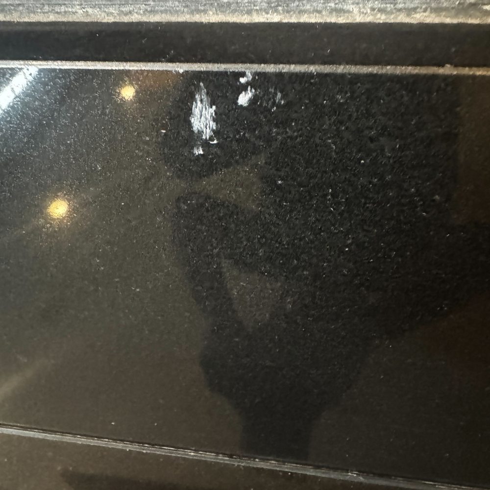 Chicago Chimney Service - Sealant that was left on outside marble facade of the fireplace and not cleaned up or addressed by Chimcare. - Chimney Sweeps Near Me