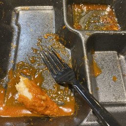 Almost eaten piece of Chicken Strip dunked in Nuclear Sauce