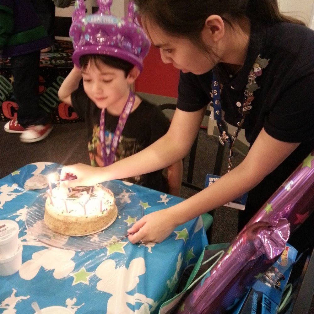 Chuck E. Cheese - Our party hostess lighting the candles. She was amazing. So sweet and great with my son. - Pizza Near Me - Olympia, Washington