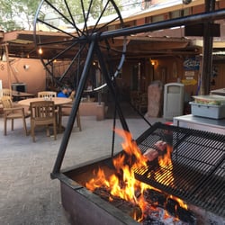 Mexican Hat Lodge - Meat cooks on a swinging g