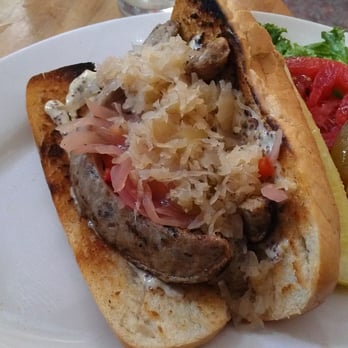 Outer Banks Brewing Station - Bratwich - Weeping Radish sausage w/ grilled sweet peppers & onions, a creamy mustard & tomato, lettuce & a pickle on the side. - Seafood Near Me - Kill Devil Hills, North Carolina Outer Banks Brewing Station - Bratwich - Weeping Radish sausage w/ grilled sweet peppers & onions, a creamy mustard & tomato, lettuce & a pickle on the side. - Seafood Near Me - Kill Devil Hills, North Carolina