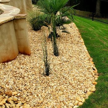 Manuel's Lawnscape - River rock flower bed - Landscaping Near Me