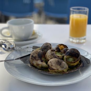 Bistro Vida - a plate of snails and a glass of orange juice - French Near Me - Menlo Park, California