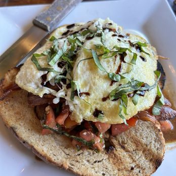 Oyo - Oyo Breakfast - Grilled cast iron skillet toast topped with apple wood bacon slab, organic cage free eggs, tomato confit and rosemary balsam - Latin American Near Me - Pleasanton, California Oyo - Oyo Breakfast - Grilled cast iron skillet toast topped with apple wood bacon slab, organic cage free eggs, tomato confit and rosemary balsam - Latin American Near Me - Pleasanton, California
