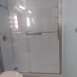 a white toilet and shower