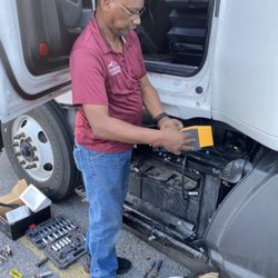 Long Roadside Assistance - Installing new batteries and checking the charging system.