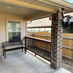 3:12 Custom Exteriors - Cedar bar top, metal railing installed. This area used to have nothing in this area. Fan mounted.