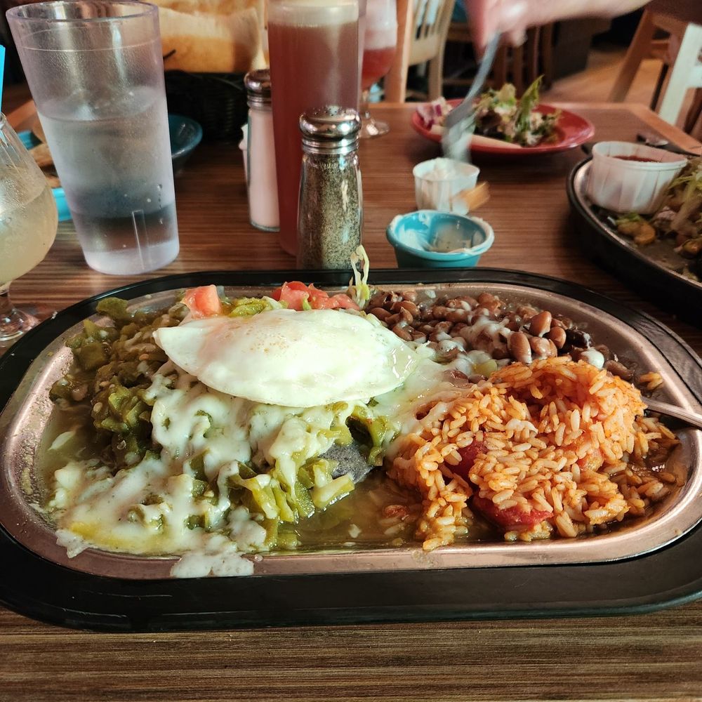Tomasita's - Blue corn chicken enchiladas cvd in green w over easy egg on top - New Mexican Cuisine Near Me - Santa Fe, New Mexico Tomasita's - Blue corn chicken enchiladas cvd in green w over easy egg on top - New Mexican Cuisine Near Me - Santa Fe, New Mexico
