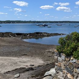 a view of a sandy beach with boats in the distance a view of a sandy beach with boats in the distance