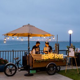 a man selling donuts from a cart