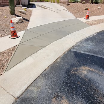 520 Construction - a man riding a skateboard down a street - Masonry/Concrete Near Me - Tucson, Arizona