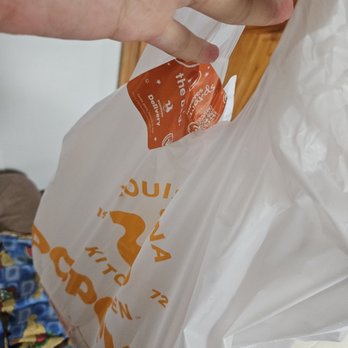 Popeyes Louisiana Kitchen - a person holding a bag of food - Chicken Wings Near Me - Bronx, New York Popeyes Louisiana Kitchen - a person holding a bag of food - Chicken Wings Near Me - Bronx, New York