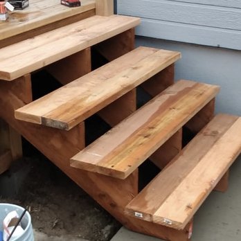 Arias Builders - a set of wooden stairs - General Contractors Near Me