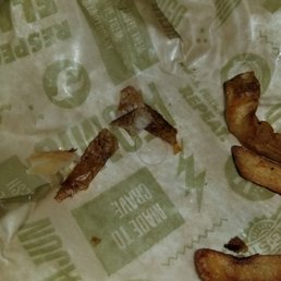 The hair we found at the bottom of the fries. We love wing stop and the food just wasnt to happy about the hairs. The hair we found at the bottom of the fries. We love wing stop and the food just wasnt to happy about the hairs.