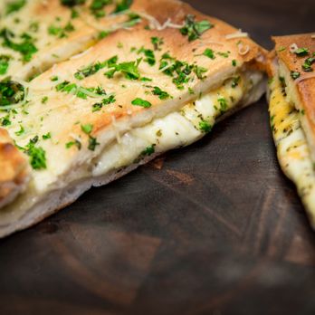 Bondi's Pizza - a piece of pizza with cheese and herbs - Pizza Near Me - London, Ontario Bondi's Pizza - a piece of pizza with cheese and herbs - Pizza Near Me - London, Ontario