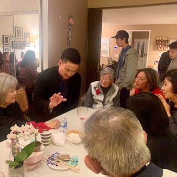 Tam Vo - Tam doing close-up magic at our Christmas Eve party - Magicians Near Me Tam Vo - Tam doing close-up magic at our Christmas Eve party - Magicians Near Me