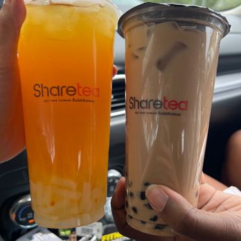 Share Tea - a person holding a drink and a drink in a car - Bubble Tea Near Me - Charlotte, North Carolina