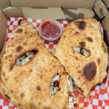 Hot Rod Willy's Pizza - The calzone customized with Alfredo sauce (this is the normal size and it was so huge they had to cut it in half to fit the box ) - Pizza Near Me - Fresno, California Hot Rod Willy's Pizza - The calzone customized with Alfredo sauce (this is the normal size and it was so huge they had to cut it in half to fit the box ) - Pizza Near Me - Fresno, California