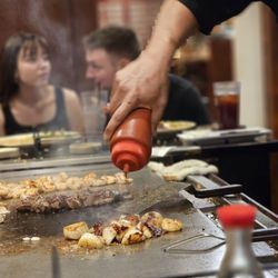 Ichiban Japanese Steakhouse - Pouring something over the food.