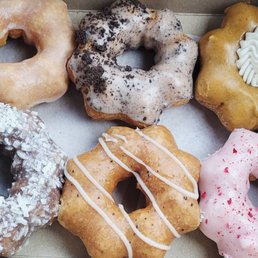a variety of doughnuts in a box a variety of doughnuts in a box