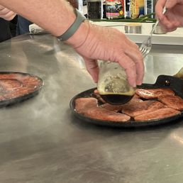 Spam slices getting a drizzle of the homemade teriyaki sauce Spam slices getting a drizzle of the homemade teriyaki sauce