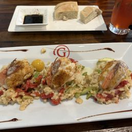 Blue crab stuffed shrimp over vegetable risotto.