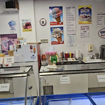 Bratcher's Ice Cream Parlor - The ice cream display freezers up front, with the signs on the wall in the background. - Ice Cream & Frozen Yogurt Near Me - Roanoke, Virginia