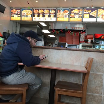 Pizza Pizza - a man sitting at a table in a restaurant - Pizza Near Me - Winnipeg, Manitoba Pizza Pizza - a man sitting at a table in a restaurant - Pizza Near Me - Winnipeg, Manitoba