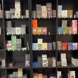 Playing Card Decks - A small glimpse of available playing cards nearly organised on a display shelf.