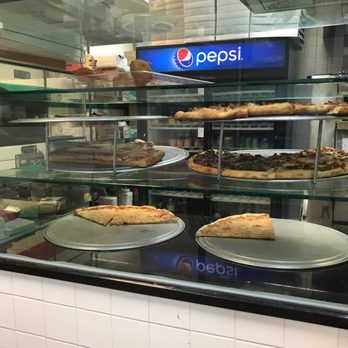 Three Brothers Pizzeria - a display of pizzas - Pizza Near Me - Brooklyn, New York Three Brothers Pizzeria - a display of pizzas - Pizza Near Me - Brooklyn, New York