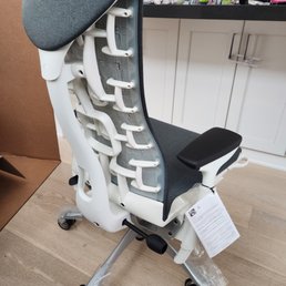 Herman Miller Embody Chair with White Frame, Titanium base, Dark Carbon upholstery and translucent casters.