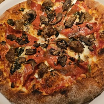 California Pizza Kitchen - THE WORKS Spicy Italian sausage, rustic pepperoni,mushrooms, Mozzarella, onions, green peppers, olives and oregano - Pizza Near Me - Long Beach, California