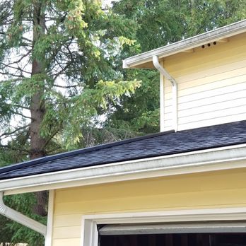 Mountain Goat Roofing - AFTER. Front view after re-roofing, showing the color-coordinated gutter pipe atop the new tiles. - Lynnwood, WA Mountain Goat Roofing - AFTER. Front view after re-roofing, showing the color-coordinated gutter pipe atop the new tiles. - Lynnwood, WA