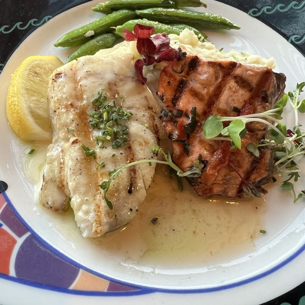 Anthony's Pier 66 - Salmon and Alaska halibut combo plate - served over rice with a chive butter and sun-dried tomatoes sauce over the salmon. - Seafood Near Me - Seattle, Washington Anthony's Pier 66 - Salmon and Alaska halibut combo plate - served over rice with a chive butter and sun-dried tomatoes sauce over the salmon. - Seafood Near Me - Seattle, Washington