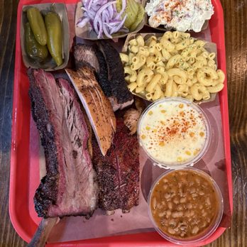 Terry Black's Barbecue - Assortment of brisket, ribs (pork and beef), and turkey along with sides (mac and cheese, beans, creamed corn, potato salad) - Barbeque Near Me - Austin, Texas Terry Black's Barbecue - Assortment of brisket, ribs (pork and beef), and turkey along with sides (mac and cheese, beans, creamed corn, potato salad) - Barbeque Near Me - Austin, Texas