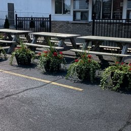 Picnic tables in front of building . Picnic tables in front of building .