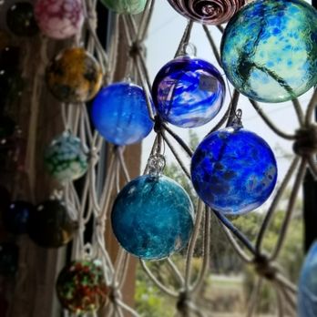 AD Glass & Design - Hand blown glass ornaments hanging in a window - Art Galleries Near Me - Bend, Oregon