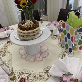 My Taste - a table setting with a cake and flowers - Bakeries Near Me - Davie, Florida