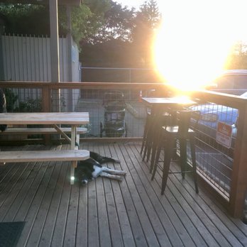 Broadview Tap House & Bottle Shop - Patio facing west over Broadview with our dog in the foreground not giving two poops about the view. - Beer Bar Near Me - Seattle, Washington