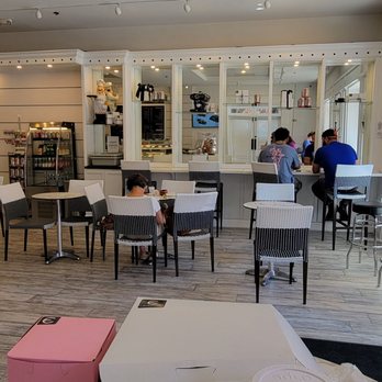 Eclairons - Most of the tables are in that area. There is a refrigerated case with beverages on the left. - Desserts Near Me - Arlington, Virginia