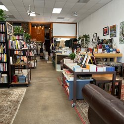 Tolima Coffee - Rows of new and used books to the left of the coffee station