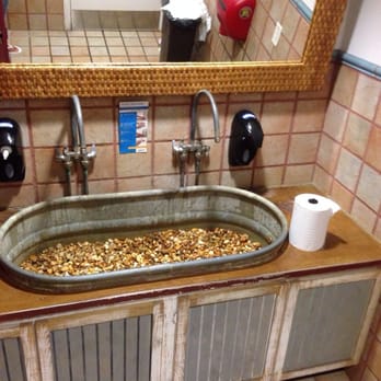 Two Drunken Goats - Sink in men's restroom is an old tin tub with gravel - Seafood Near Me - Riviera Beach, Florida Two Drunken Goats - Sink in men's restroom is an old tin tub with gravel - Seafood Near Me - Riviera Beach, Florida