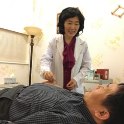 Revival Acupuncture & Herbs - Dr.Chung is treating a patient with acupuncture
