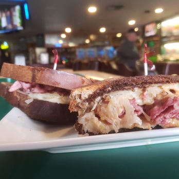 O'Blarney's Irish Pub - Hearty Reuben - Corned beef, sauerkraut, swiss cheese grilled on rye with special sauce - Sports Bars Near Me - Olympia, Washington O'Blarney's Irish Pub - Hearty Reuben - Corned beef, sauerkraut, swiss cheese grilled on rye with special sauce - Sports Bars Near Me - Olympia, Washington