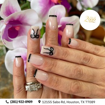 Nail & Tan 2000 - Clean, minimalist chic. Ultra-fine black French tips get a beautifully feminine upgrade with delicate hand-painted ribbon outlines. - Tanning Near Me - Houston, Texas Nail & Tan 2000 - Clean, minimalist chic. Ultra-fine black French tips get a beautifully feminine upgrade with delicate hand-painted ribbon outlines. - Tanning Near Me - Houston, Texas